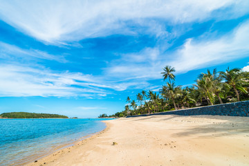 Fototapeta na wymiar Beautiful tropical beach sea and sand with coconut palm tree on blue sky and white cloud