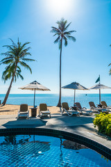 Fototapeta na wymiar Beautiful tropical beach and sea with umbrella and chair around swimming pool