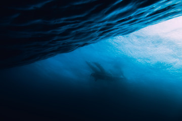 Wave is underwater and surfer. Wave crashing on beach