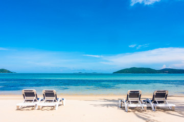 Beautiful outdoor view with umbrella and chair on the beach and sea