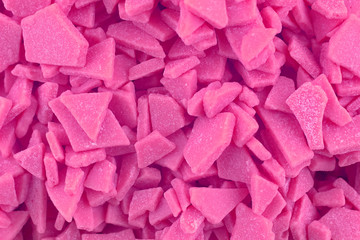 Obraz premium Candy background, copy space. Closeup of pile pastel chocolate candies. Candy texture. Candy pattern. Sweets background. Pink abstract background. Top view, flat lay