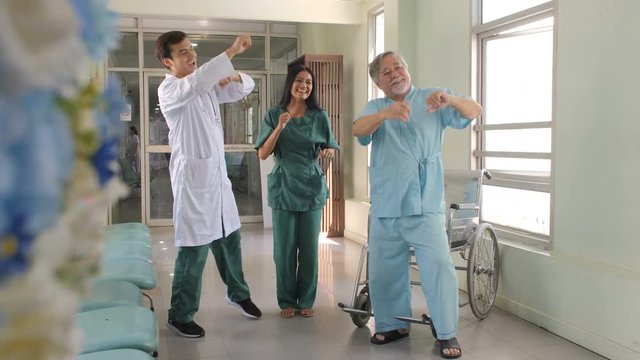 Doctor and patient dance together at hospital in slow motion.