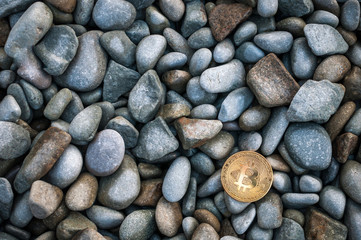 Cryptocurrency on the shore among the big sea stones