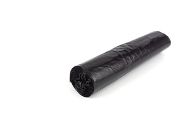 black roll of plastic garbage bags isolated on white background.