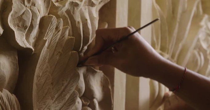 An artisan creates sculptures with chalk to make statues and works of art by hand as the manufacturing tradition teaches. Concept of: artisan, art, culture, dexterity.