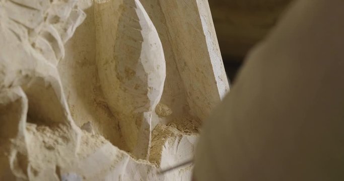 An artisan creates sculptures with chalk to make statues and works of art by hand as the manufacturing tradition teaches. Concept of: artisan, art, culture, dexterity.