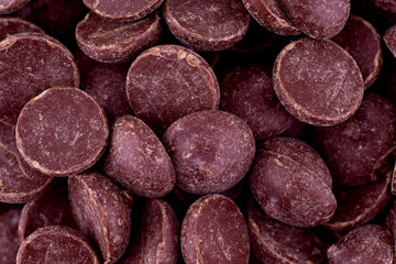 Candy dark chocolate background, copy space. Closeup of pile chocolate candies. Candy texture. Candy pattern. Sweets background. Abstract background. Top view, flat lay