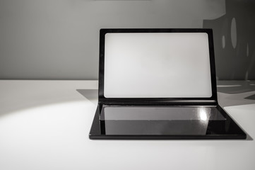 Laptop mockup on white table with copy space