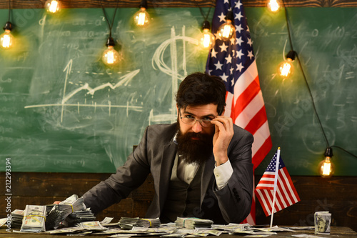 American education reform at school in july 4. Income planning of budget increase policy. Independence day of usa. Bearded man with dollar money for bribe. Economy and finance. Patriotism and freedom