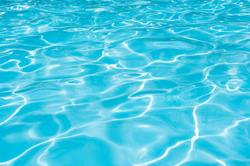 Fototapeta na wymiar Blue water surface in swimming pool for background and abstract