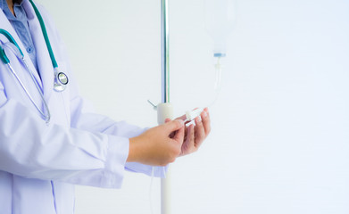 Doctor is adjusting rate of intake salt solution for recovery patient