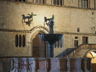 Fototapeta premium Perugia, Italy. Views of the Palazzo dei Priori an historical building of the town and the Fontana Maggiore a monumental medieval fountain