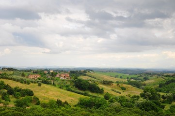 Beautiful landscape of hills, cypress trees and houses in Tuscany, Italy