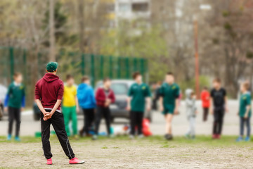 Coach stands in front of his students and gives instructions before training.