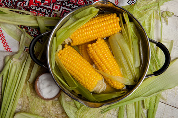 Sweet corn boil with salt. cooked sweet corn in pot on wooden table. © Nomad Pixel