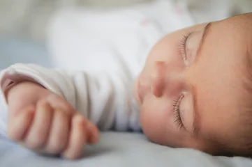 Fototapeten Newborn baby girl sleeping on blue sheets © javiindy