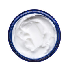 White face cream in a jar on a white