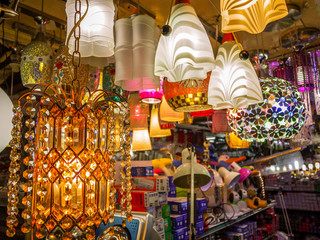 Colourful hanging lights displayed in shop for sale.
