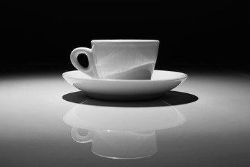 Profile of coffee cup on white and black background