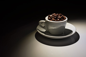 coffee cup full of roasted coffee beans