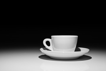 Profile of coffee cup on white and black background