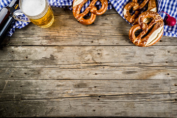 Oktoberfest food menu, bavarian pretzels with beer bottle mug on old rustic wooden background, copy space above - obrazy, fototapety, plakaty