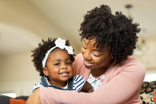 African American Family. Mother And Daughter Smiling At Home.