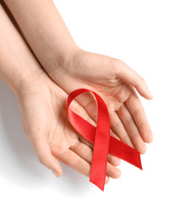 Woman holding red ribbon on white background, top view. Cancer awareness