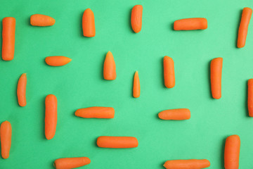 Flat lay composition with baby carrots on color background