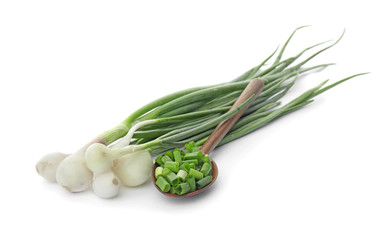 Obraz premium Spoon with chopped green onion and stems on white background