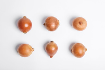 Beautiful composition with ripe onions on white background