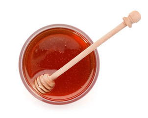 Jar with delicious honey and dipper on white background, top view