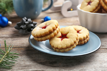Traditional Christmas Linzer cookies with sweet jam on plate