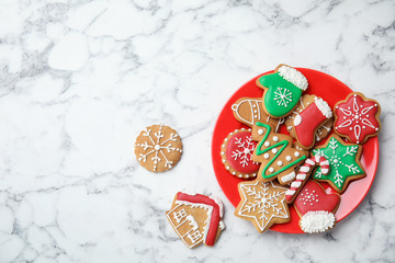 Plate with tasty homemade Christmas cookies on marble table, top view
