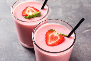Glasses with tasty strawberry smoothie, closeup