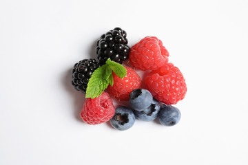 Raspberries, blackberries and blueberries on white background