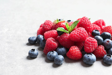 Raspberries, strawberries and blueberries on table