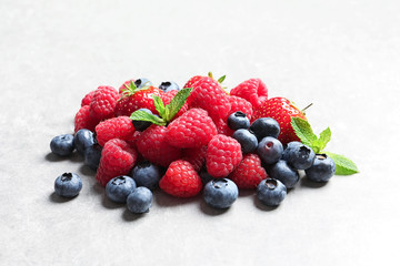Raspberries, strawberries and blueberries on table