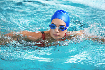 Fototapeta na wymiar Young athletic woman swimming in pool