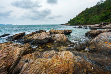 Fototapeta na wymiar Sea rocks with wave on sunset