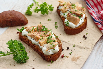 Sandwich with smoked salmon, cream cheese, spices and greens