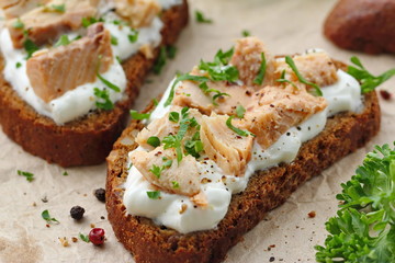 Sandwich with smoked salmon, cream cheese, spices and greens