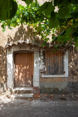 Fototapeta na wymiar Rustic old door and window in Venasque, provence, France