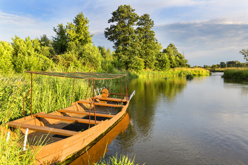 Lowland Nida river, wooden boat, landscape of the Nida Valley, Poland