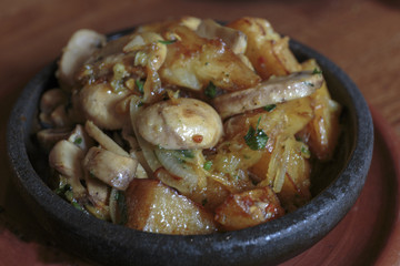 Frying pan with potato and mushrooms, stir-fried vegetables, vegan food.