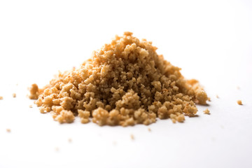 Crushed peanuts or mungfali powder with whole and roasted groundnut. Served in a bowl over moody background. Selective focus