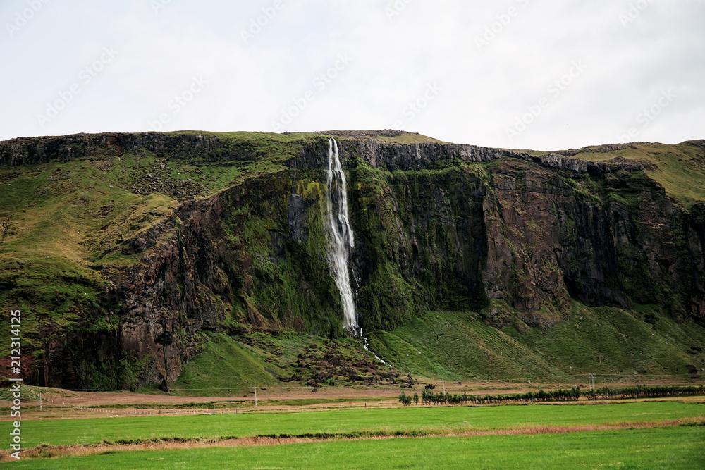 Wall mural small waterfall cascade in iceland,