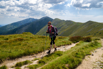 Fototapeta na wymiar Walking woman hiking on the mountains