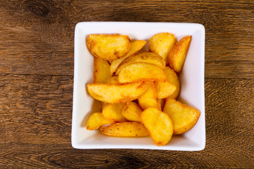 Rustic potato over wooden background