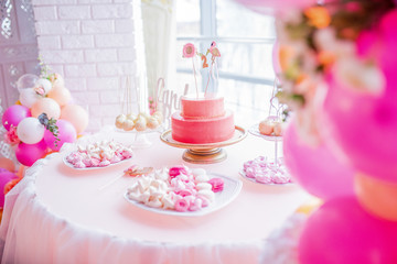 Candybar for child's birthday decorated withpink balloons and flamingos